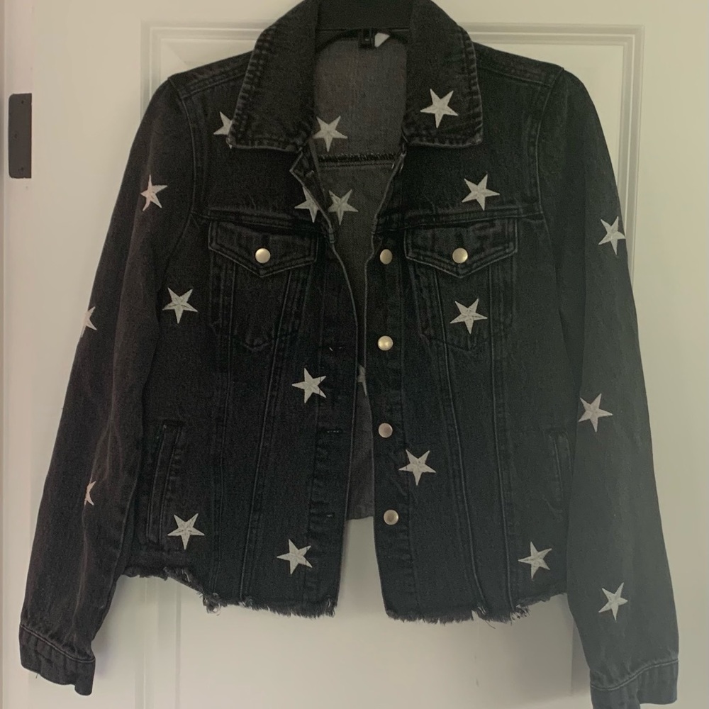 Distressed black denim jacket with white stars